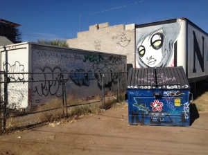 This alley way is home to several works of street art as well as the dumpster piece.